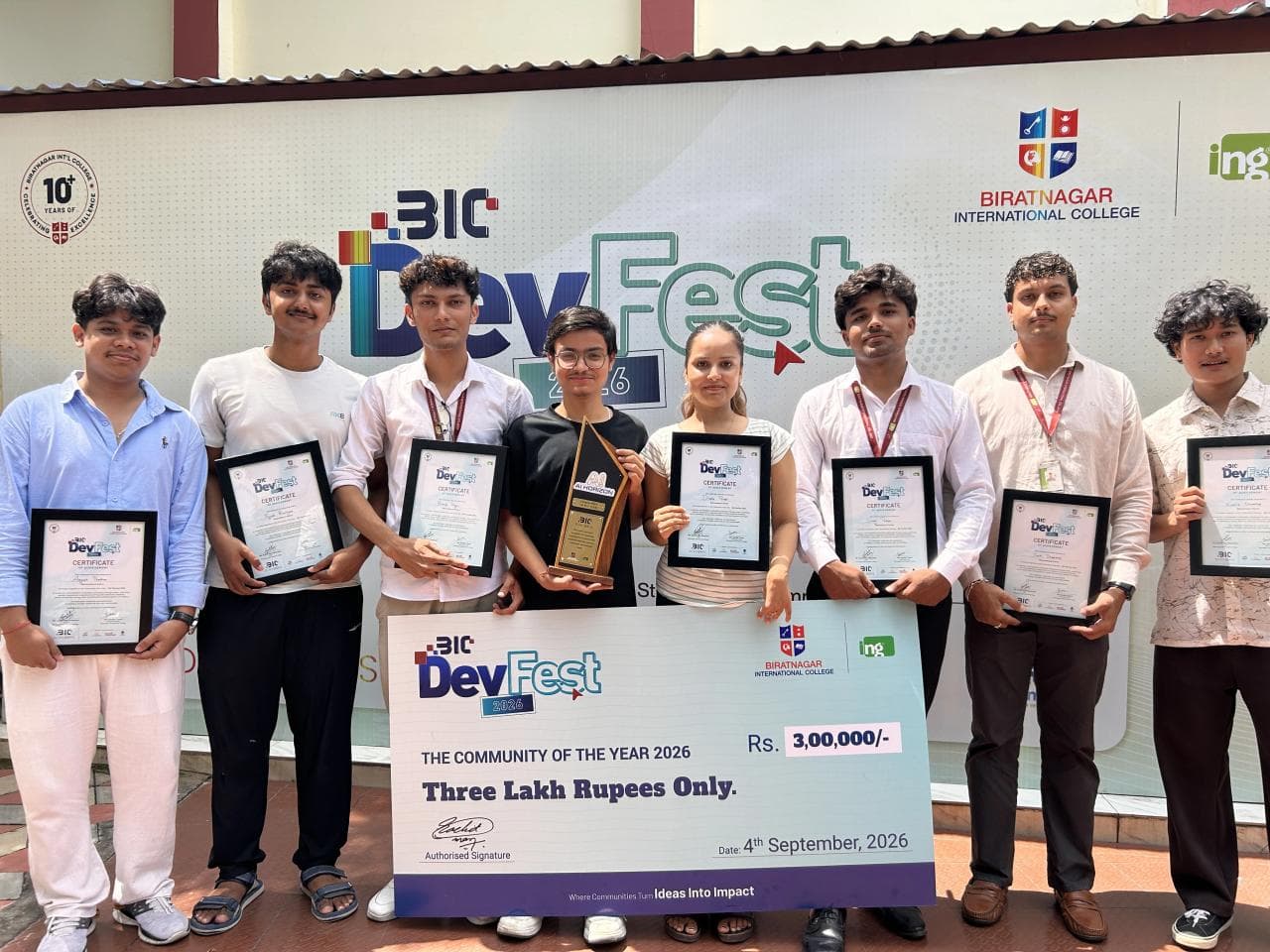 AI Horizon members holding framed DevFest 2026 certificates and the Community of the Year trophy